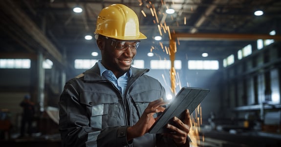 Technician using a tablet in a fabrication shop | SDS2 Steel Detailing Software